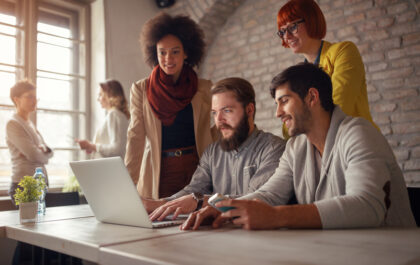 Image of web designers gathered around a computer